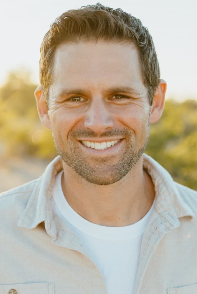 Portrait of Scott Donnell smiling outdoors at golden hour.
